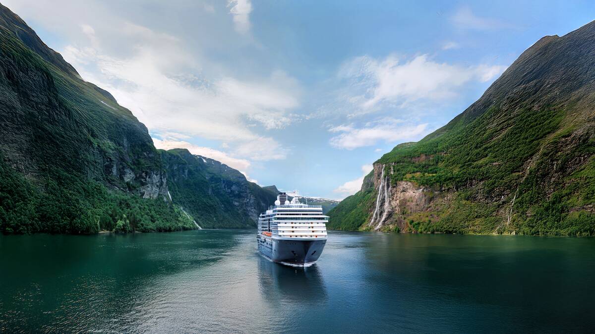 A Holland America Line ship cruising through Norwegian fjords.