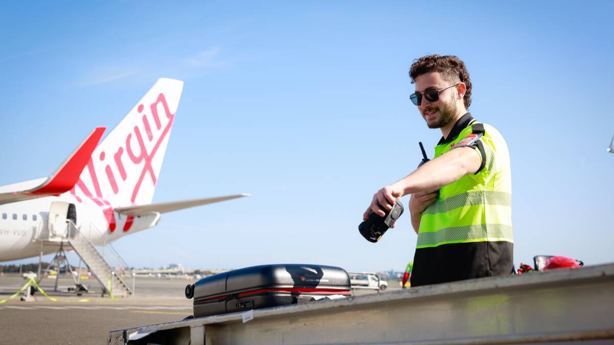 A Virgin Australia baggage handler. A Virgin Australia baggage handler.