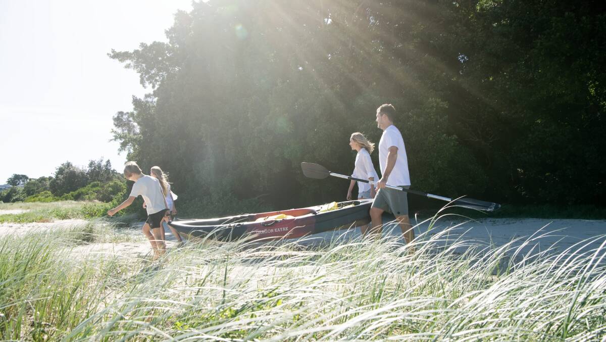 A family kayaking at North Creek Beach in Ballina. Picture by Destination NSW