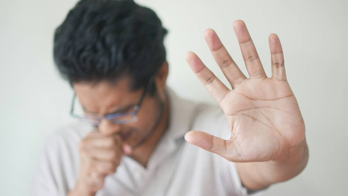 A man coughs. Picture by Unsplash