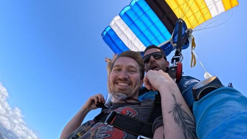 Gold Coast resident Mitch Cornish (left), 30, skydiving at Kirra Beach. Gold Coast resident Mitch Cornish (left), 30, skydiving at Kirra Beach.