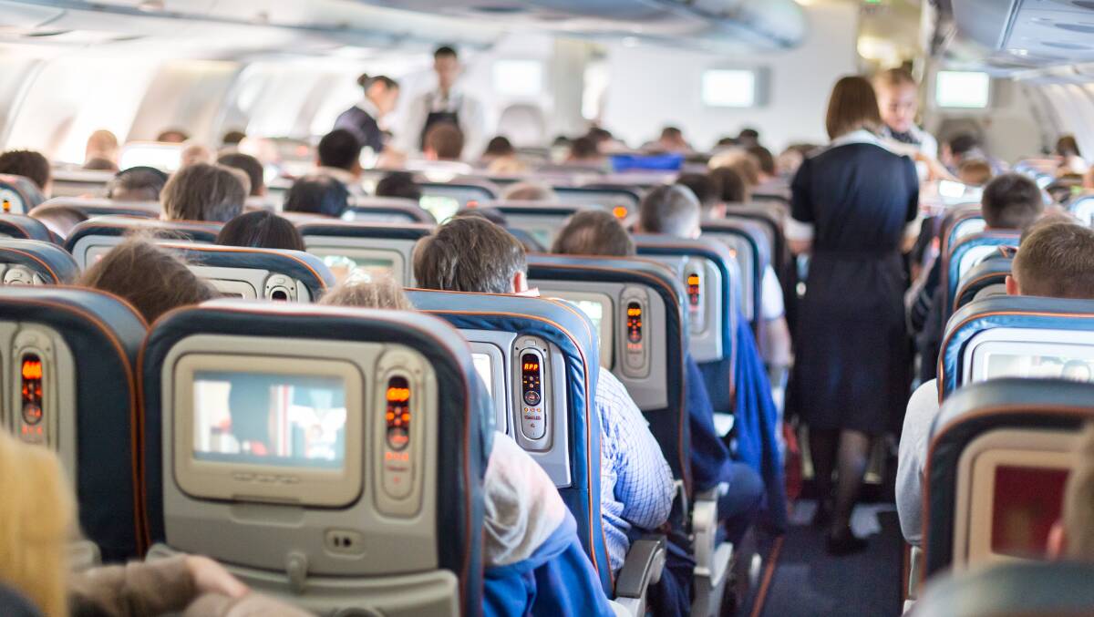 Flight attendants serve meals to customers during a flight. Picture by Shutterstock