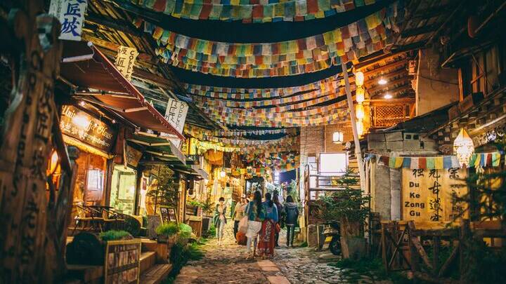 A street with prayer flags in China. Picture by Intrepid Travel