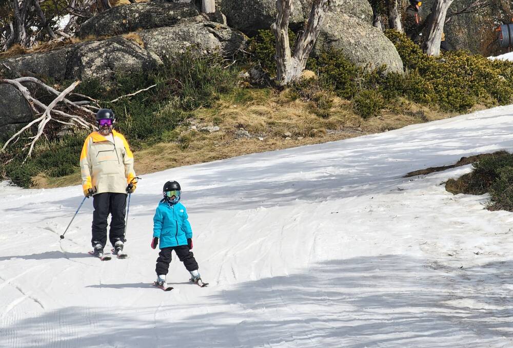 Simon Cohen and daughter skiing on a sunny bluebird, spring day at Perisher. Picture by Desiree Savage