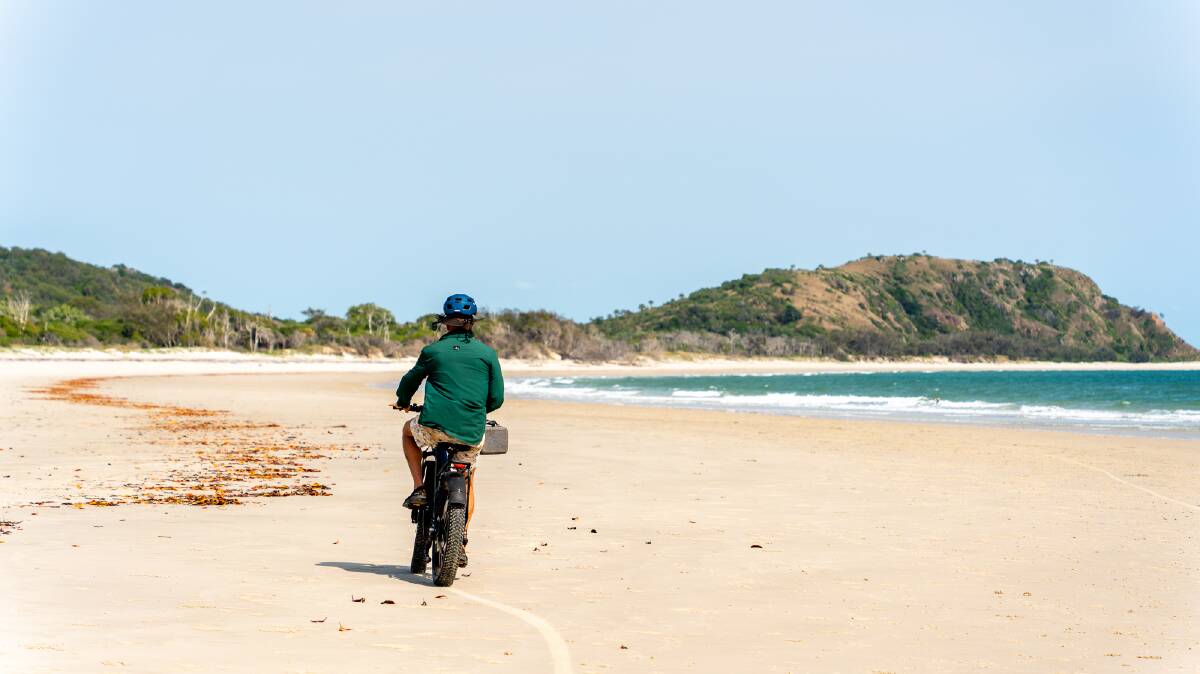 Riding ebikes on the deserted beach. By Michael Turtle