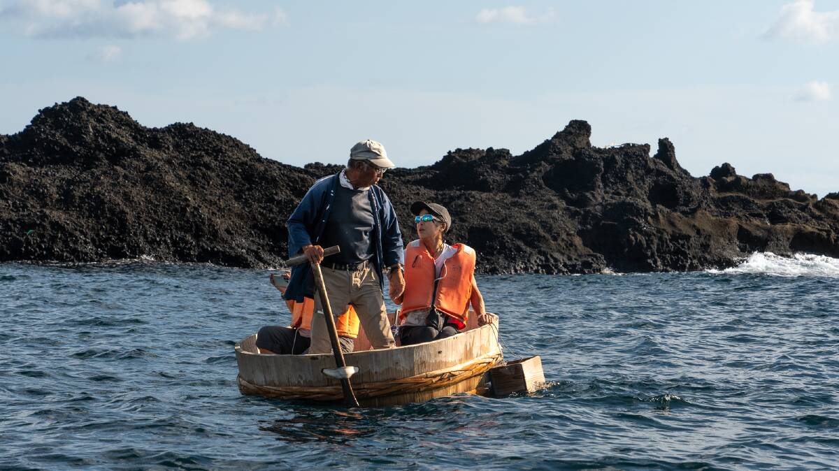 Keiji Kaneko takes visitors for a ride in a tub boat. Picture by Michael Turtle