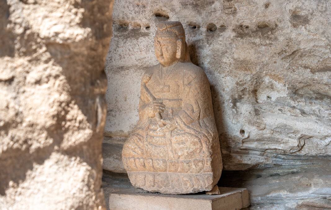An ancient Buddha statue at Yungang Grottoes.