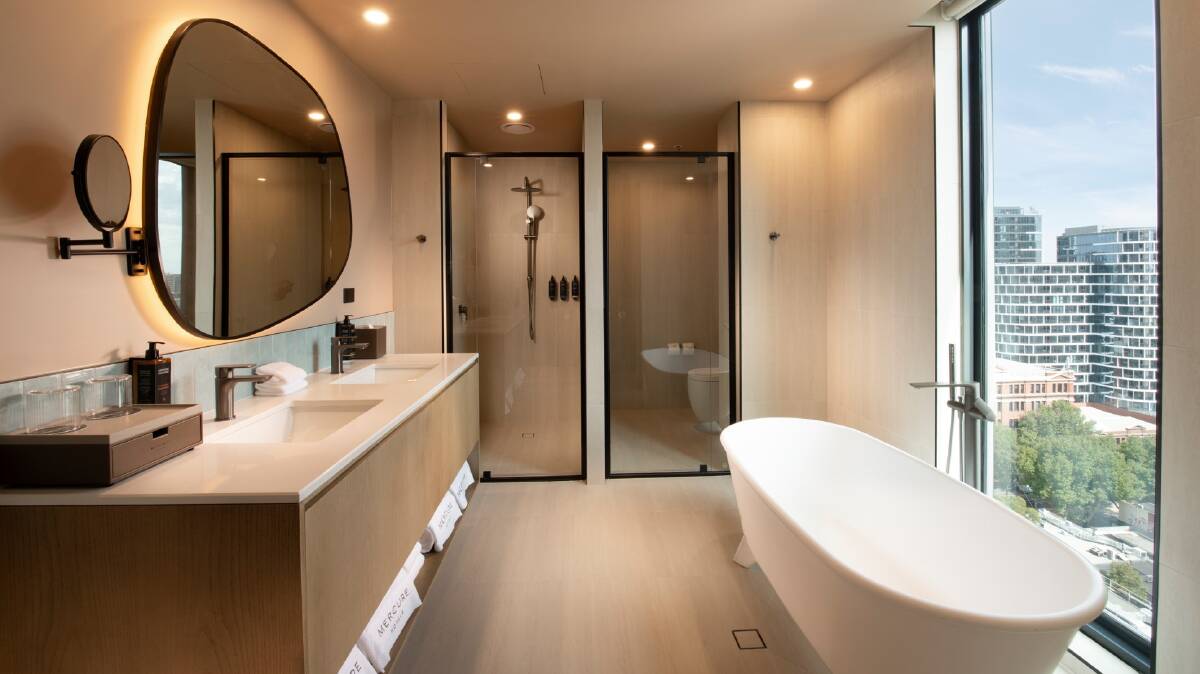 The superior suite boasts a two-person bathtub positioned against a window that overlooks the city.