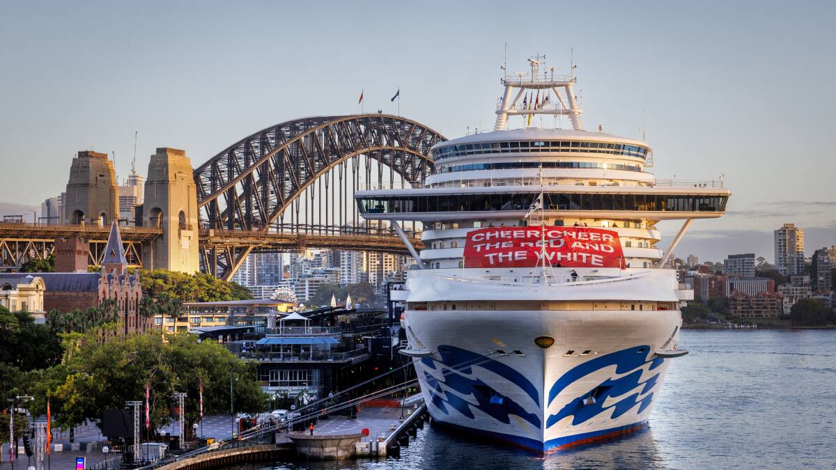 The Crown Princess bearing the Sydney Swans banner: "Cheer, cheer, the red and the white." The Crown Princess bearing the Sydney Swans banner: "Cheer, cheer, the red and the white."