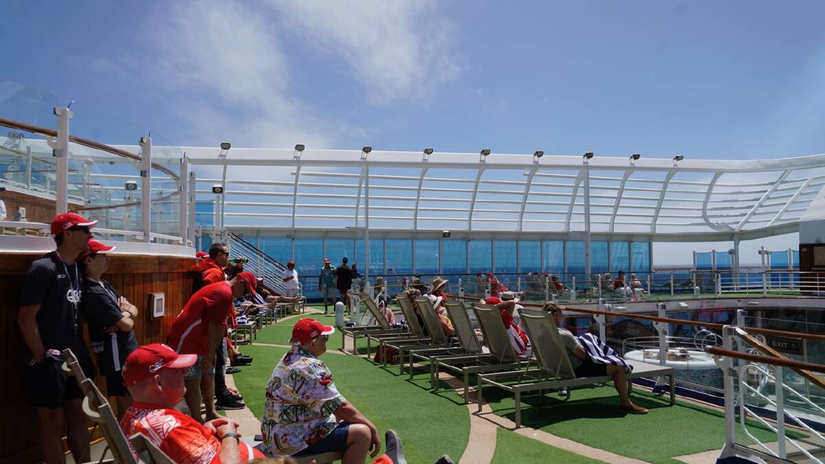 Swans members take in the sun and the 2024 season highlights up on deck. Picture: Zhenshi van der Klooster Swans members take in the sun and the 2024 season highlights up on deck. Picture: Zhenshi van der Klooster