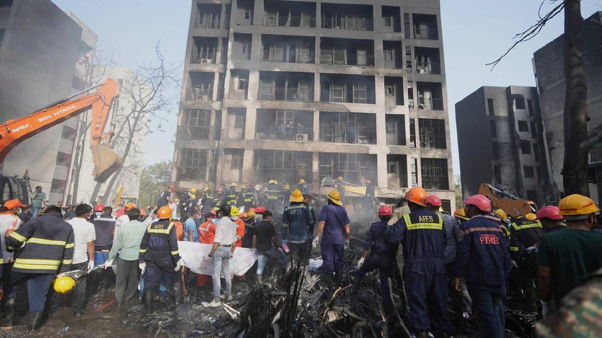 Rescuers search buildings for missing people, and aircraft parts that could shed light on the crash. (AP PHOTO)