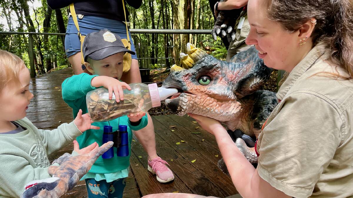 Nellie and Teddy getting up close and personal with a baby triceratops thanks to the friendly rangers. Picture: Benjamin Palmer Nellie and Teddy getting up close and personal with a baby triceratops thanks to the friendly rangers. Picture: Benjamin Palmer
