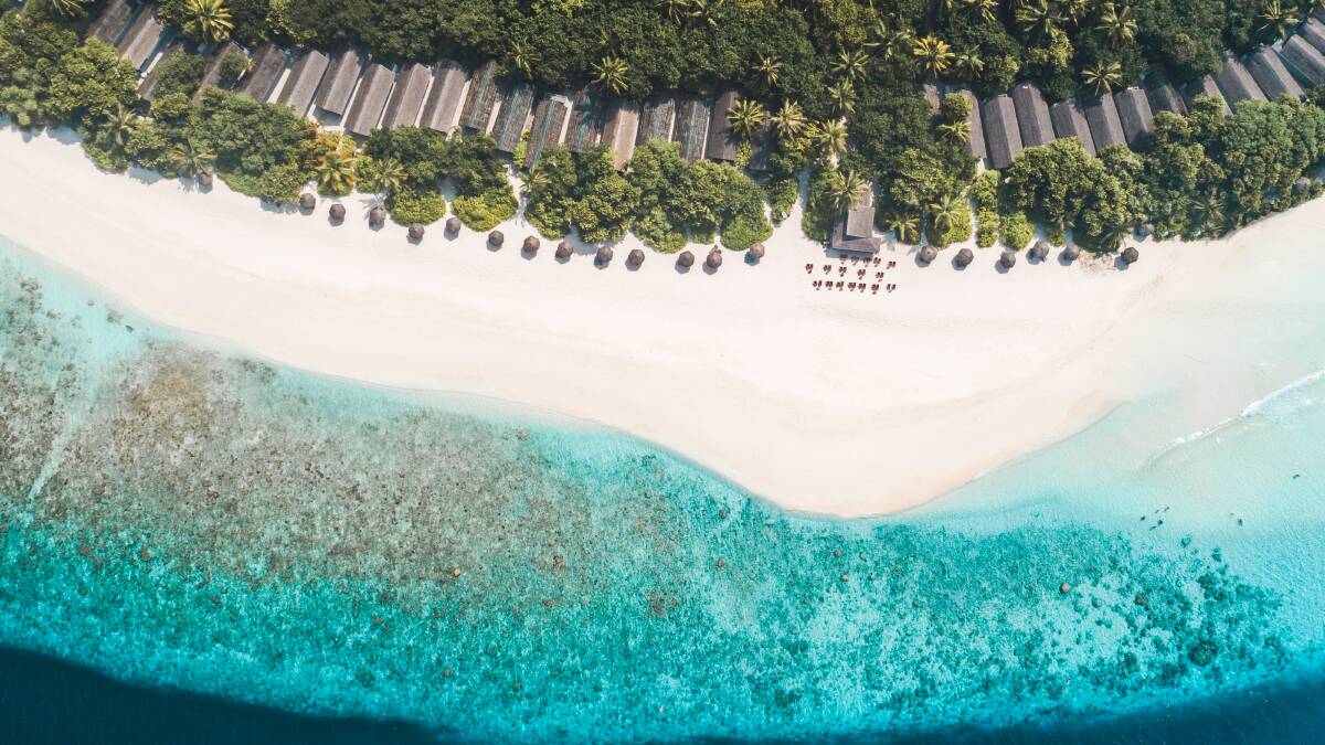 An aerial view over the NH Collection Maldives Reethi Resort. An aerial view over the NH Collection Maldives Reethi Resort.