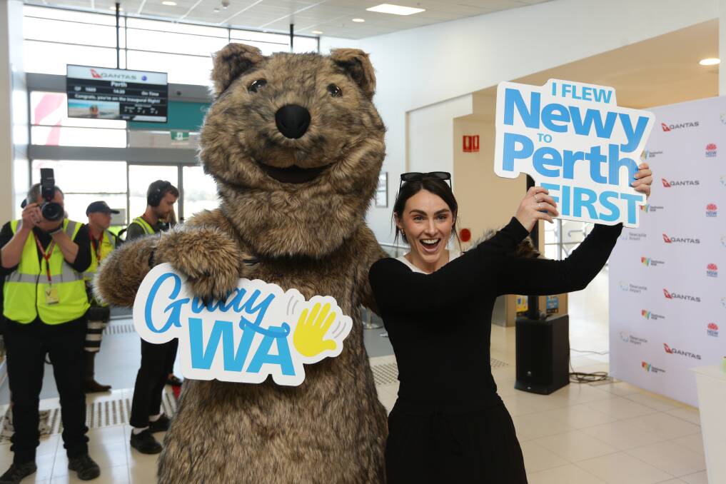 Anna Malone with Sunny the Quokka at the Newcastle Airport departure gates, waiting to board the first direct flight to Perth. Picture by Jonathan Carroll Anna Malone with Sunny the Quokka at the Newcastle Airport departure gates, waiting to board the first direct flight to Perth. Picture by Jonathan Carroll